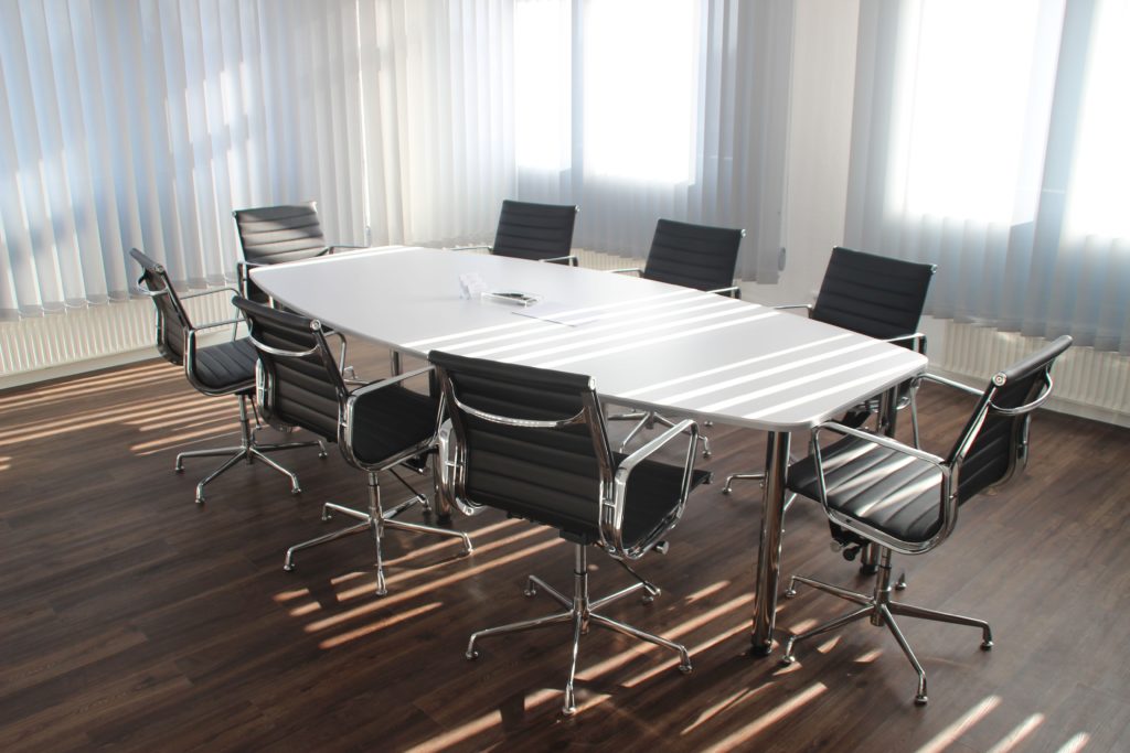 White table with black set of chairs.